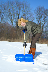 Image showing Woman shoveling after a snow storm