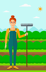 Image showing Farmer with rake.