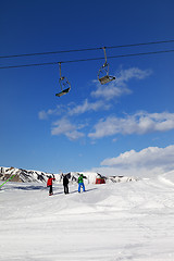 Image showing Three skiers on slope at sun day