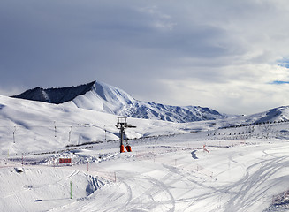 Image showing Ski slope with surface lift and gray sky