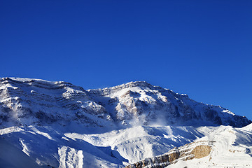 Image showing Snowy mountains at sun windy day