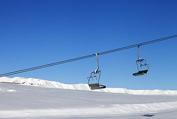 Image showing Chair-lift and blue clear sky at sun day