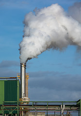 Image showing Steaming Pipe on Blue Sky Background