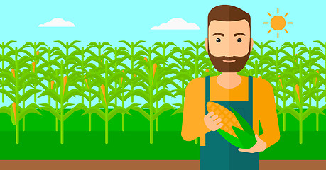 Image showing Farmer holding corn.