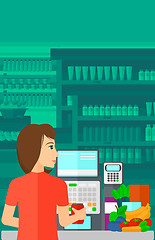 Image showing Cashier at supermarket checkout.