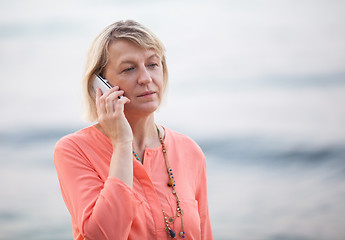 Image showing Blond woman having a phone talk outdoor