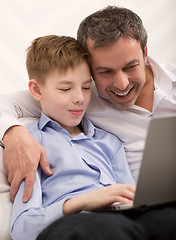 Image showing Happy dad and son with laptop at home