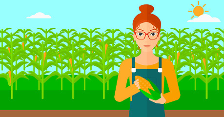 Image showing Farmer holding corn.
