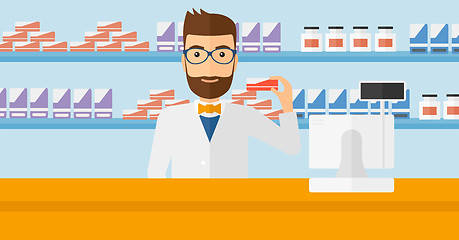 Image showing Pharmacist showing some medicine.