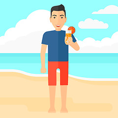 Image showing Tourist with cocktail on the beach.