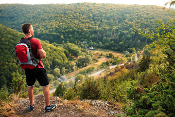 Image showing Active tourist on the top of mountain enjoying landscape