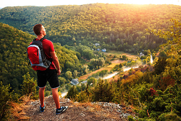 Image showing Active tourist on the top of mountain enjoying landscape