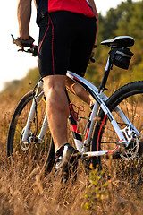 Image showing Close up rear view of man spining bike pedals