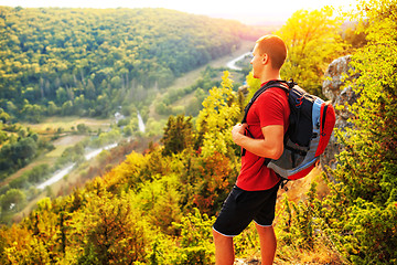 Image showing Active tourist on the top of mountain enjoying landscape