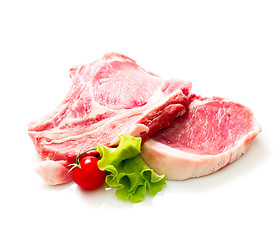 Image showing Pieces of raw beef with tomato and salad isolated on white background