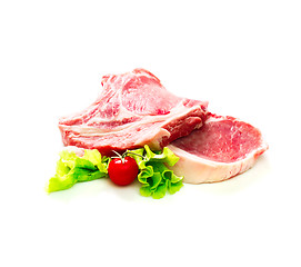 Image showing Pieces of raw beef with tomato and salad isolated on white background