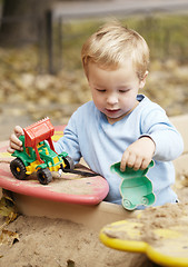 Image showing Boy playing with toy outdoor.