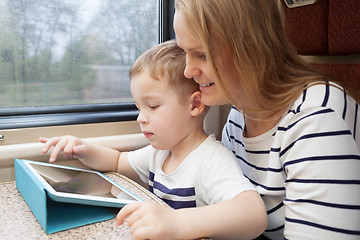 Image showing Mother and her young son on a train