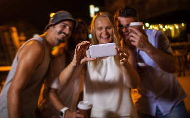 Image showing Happy friends making phone selfie at night