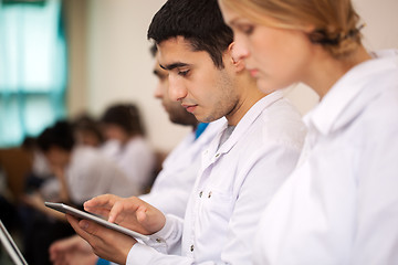 Image showing Medical student working with pad on the conference