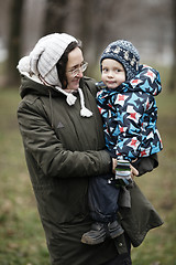 Image showing Woman holding her small son