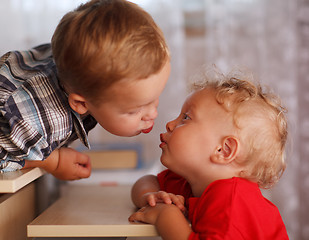 Image showing Cute siblings. Two little brothers are kissing.