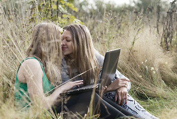 Image showing Two women friends sitting outdoors together