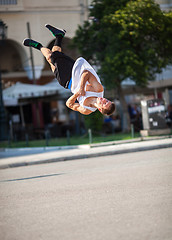 Image showing Man doing acrobatic tricks in city street