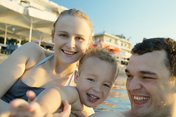 Image showing Happy young family at the seaside