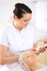 Image showing Cosmetician with cosmetic before procedure