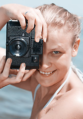 Image showing Woman laughing as she views a photo