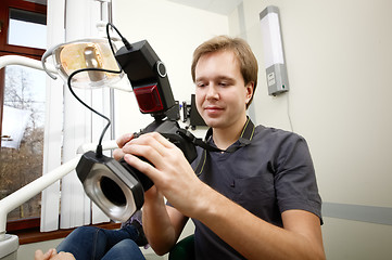 Image showing Dentist making photos of patients smile