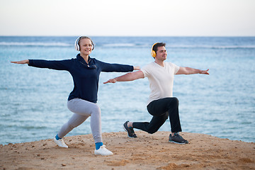 Image showing Young couple working out outdoor with music