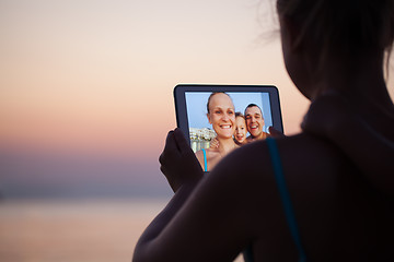 Image showing Family selfie with pad on the beach