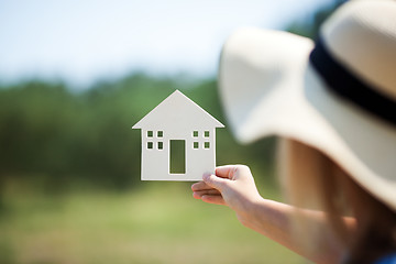 Image showing Woman holding house model in the countryside