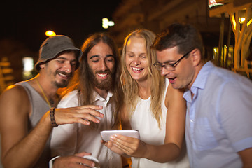 Image showing Friends looking at great shots of today evening