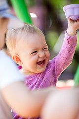 Image showing Laughing little baby playing with a toy