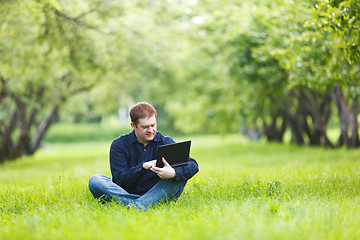 Image showing Man working with notebook in the park.