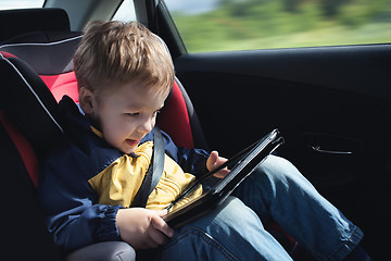 Image showing Child in the car with tablet PC