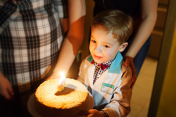 Image showing Little boy carrying birthday cake