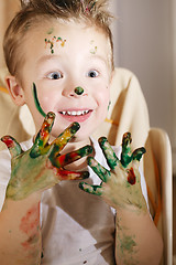 Image showing Cute excited boy with hands full of finger paint