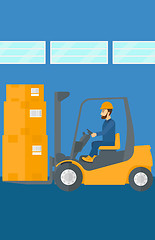 Image showing Warehouse worker moving load by forklift truck.