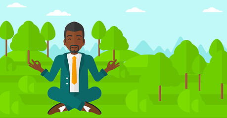 Image showing Businessman meditating in lotus pose.