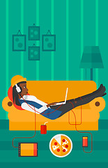 Image showing Woman lying on sofa with many gadgets.