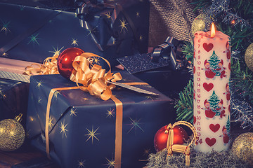 Image showing Christmas gifts with a Xmas candle