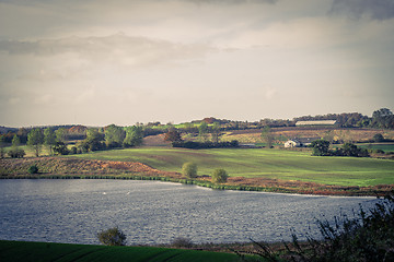 Image showing Countryside landscape with a farm and a lake