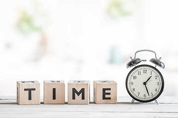 Image showing Alarm clock on a wooden desk