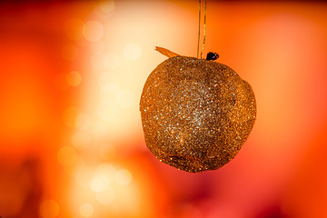 Image showing Golden Christmas apple with glittering lights