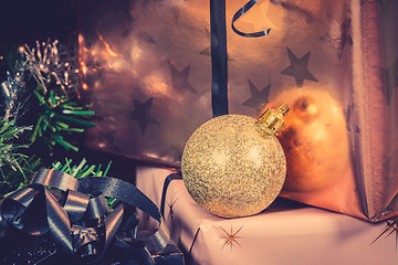 Image showing Golden Xmas bauble and a present