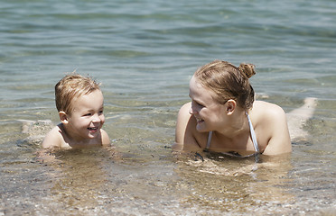 Image showing Mother and son swim in the sea